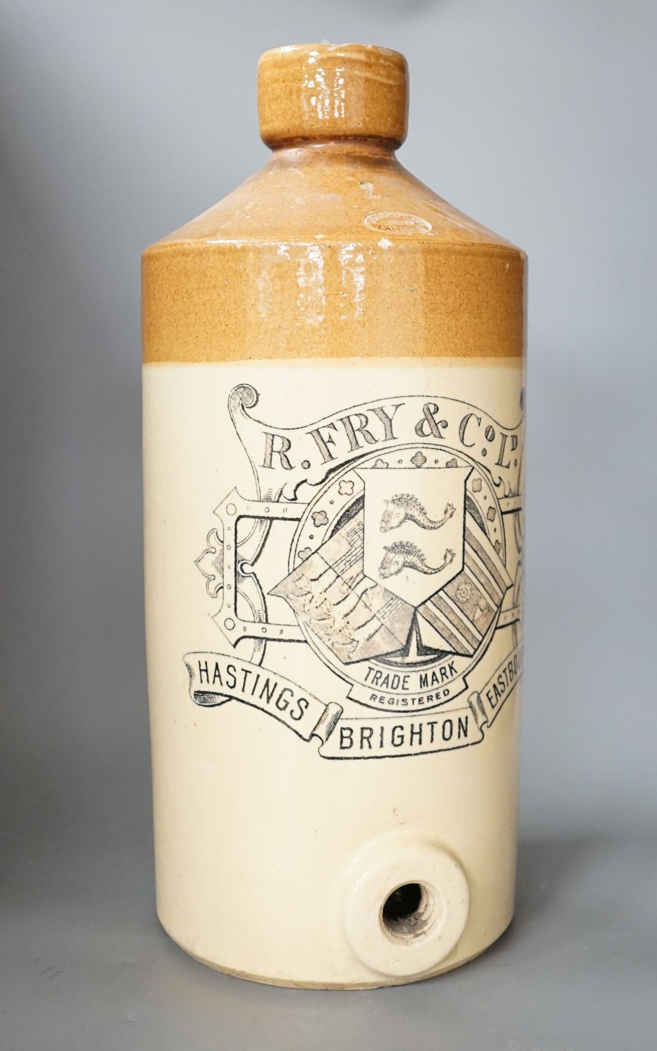 A stoneware bottle, R Fry & Co Ltd, Hastings, Brighton and Eastbourne, stamped Doulton Lambeth, 47 cms high.